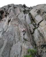 Unknown on Lundeklubben (6) at Festvag. The 3 pitch route continues up the square cut grove with capping overhang.