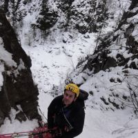 Gareth on belay duty at the top of P1 of Tungtvann WI4, Vermok Bridge (Andy Stratford)