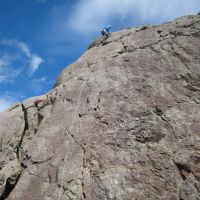 Colin high on Glaciated Slab (Roger Dyke)