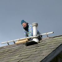 Joe accessing the damage roof (Dave Wylie)