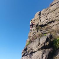 Tommy Harrisson eyes up the crux top move on Noddys Wall (Andy Stratford)