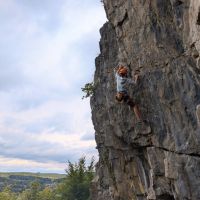 Tom pulling past the crux section of Cave and Crag, 7a